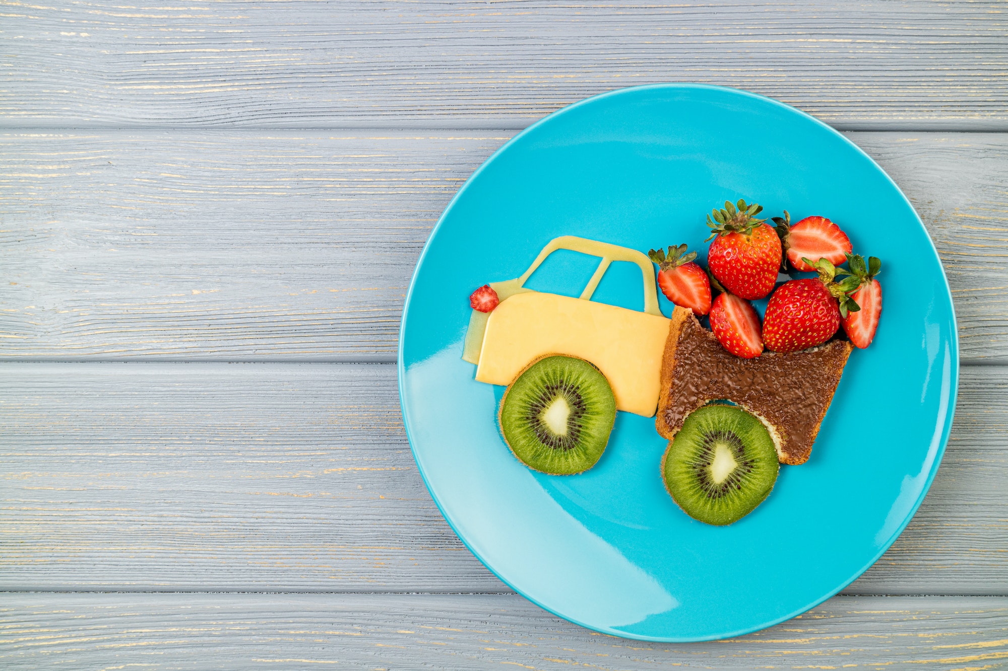 Funny kids food. Children's breakfast with sandwich and berries. Cute car truck sandwich