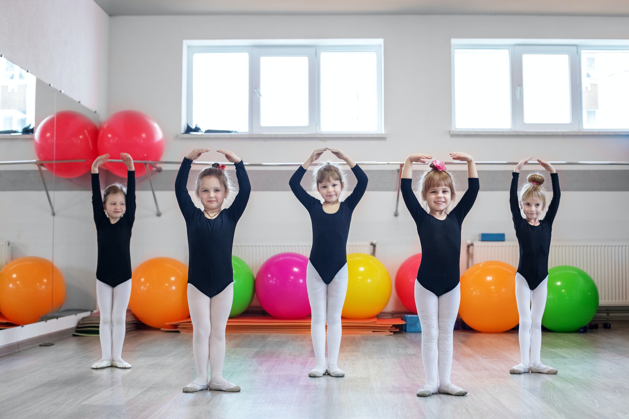 Little kids dance in dance class. The concept of sport, education, childhood, hobbies and dance.